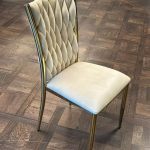 Golden chair with a beige pillow