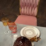 Golden chair with a pink pillow