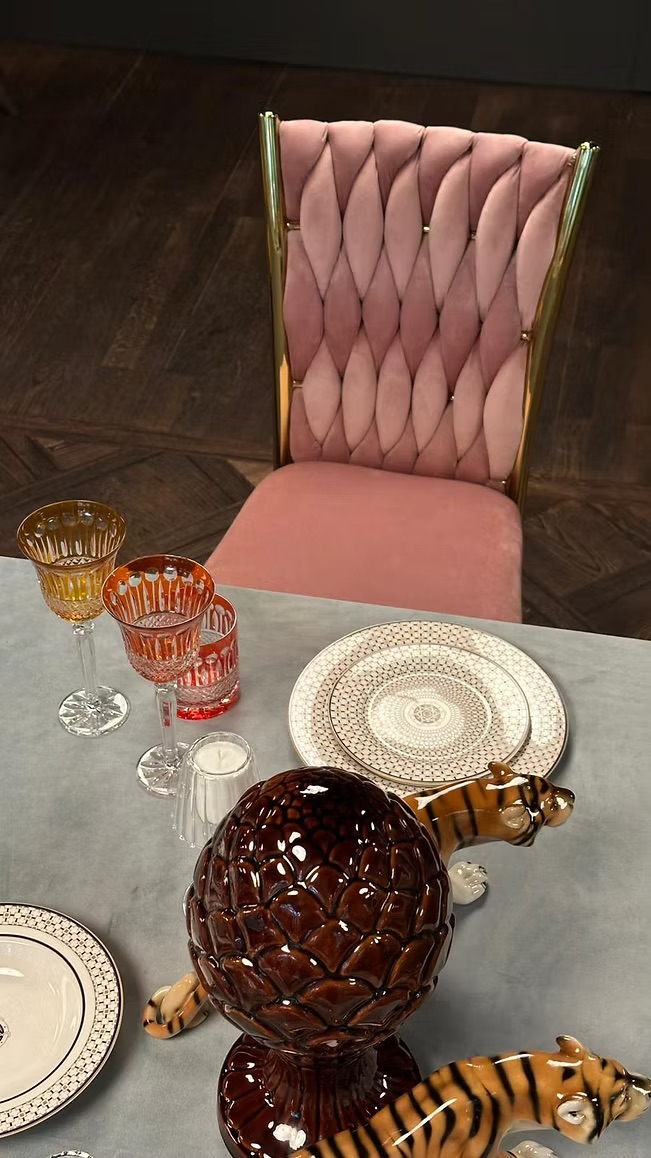 Golden chair with a pink pillow