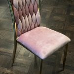 Golden chair with a pink pillow