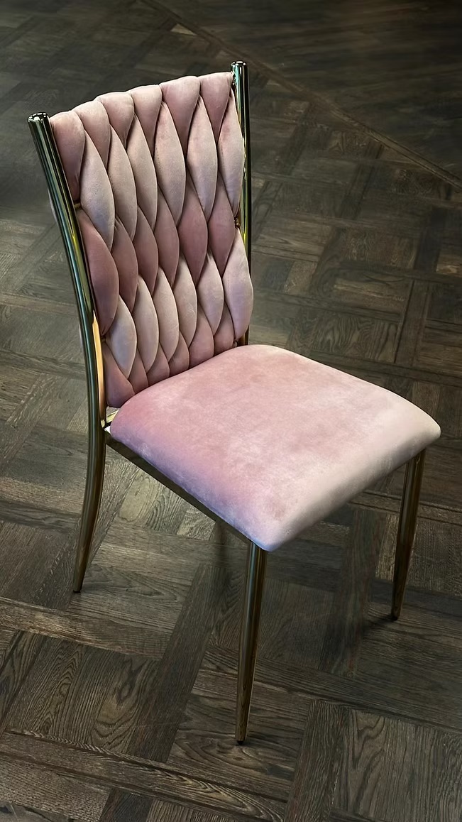 Golden chair with a pink pillow