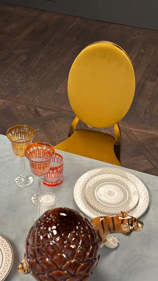 Gold chair with amber cushion