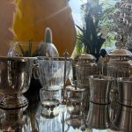 Glass containers with metal holder